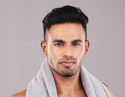 Buy stock photo Portrait, man and exercise for wellness, towel for workout and grey studio background. Young Indian male, confident and focus for organic facial, proud and clear skin being determined and on break.