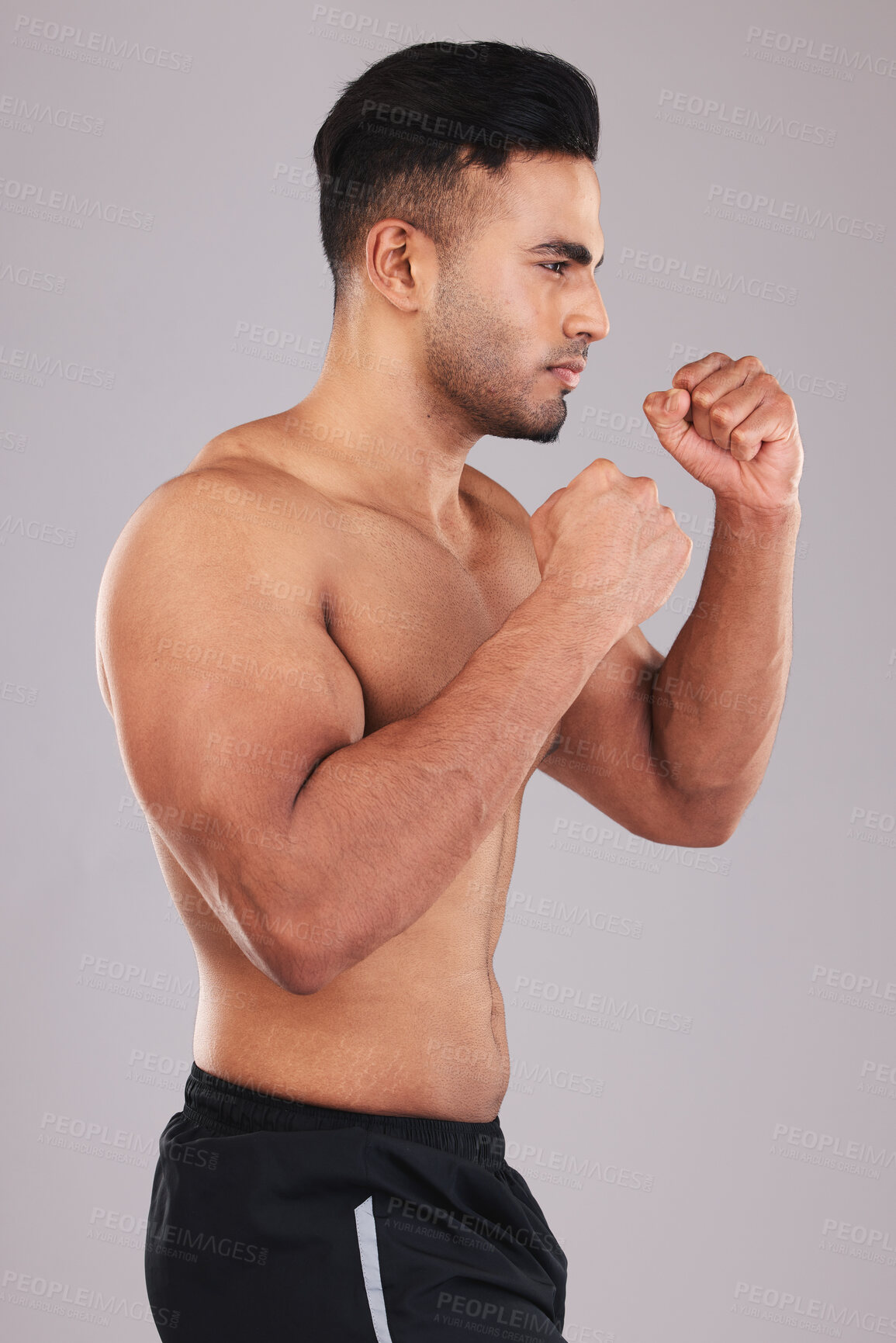 Buy stock photo Boxing, fight and man training for a competition, event or match against a grey studio background. Fitness, exercise and focus boxer with motivation, muscle and power in fist for a fighting sport