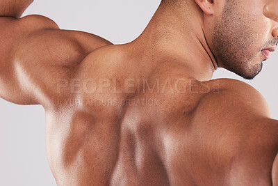 Buy stock photo Back, bodybuilder and flex muscle for competition, weightlifting and pride for body care in studio background. Male athlete, demonstrate biceps and shoulders ready for performance and fitness workout