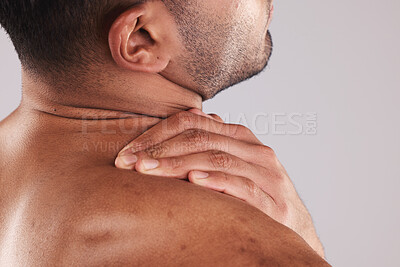 Buy stock photo Man hand holding neck pain, hurt and body injured problem in studio. Male model hands from behind suffering with sore body injury, discomfort and strain or muscle sprain from fractured  joints 