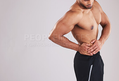 Buy stock photo Fitness, sports and man with waist pain, topless in studio background. Sport injury, hurt muscle and a male model with muscular body in studio holding his side, health and body care at gym workout.