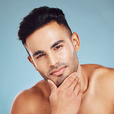 Buy stock photo Skincare, portrait and man with idea for beauty, wellness and health against a blue studio background. Thinking, cosmetic and young model with a facial beard and dermatology for cleaning of skin