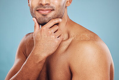Buy stock photo Hand, skincare and beauty with a man model in studio on a blue background thinking about grooming. Wellness, cosmetics and skin with a male posing to promote a natural product or antiaging treatment