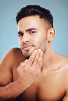 Skincare, portrait and man in blue studio thinking of facial hair wellness, health and cosmetics beauty glow. Young, sexy and face model with beard growth idea for skin care, self love or dermatology
