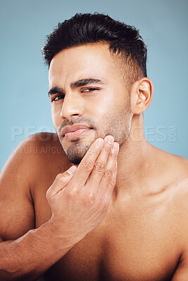 Buy stock photo Skincare, portrait and man in blue studio thinking of facial hair wellness, health and cosmetics beauty glow. Young, sexy and face model with beard growth idea for skin care, self love or dermatology