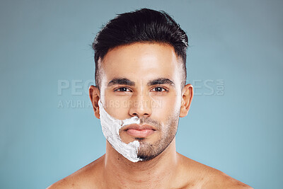 Buy stock photo Shaving cream, face and portrait of man in a studio to shave his beard with foam or creme. Beauty, skincare and model from Puerto Rico grooming or cleaning his facial hair isolated by blue background