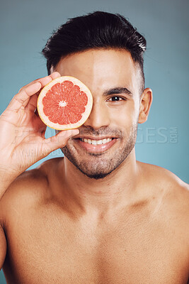 Buy stock photo Happy studio portrait, grapefruit man for skincare wellness beauty and face smile health against wall. Young cosmetics model, fruit happiness for healthy facial skin or vitamin c with blue background