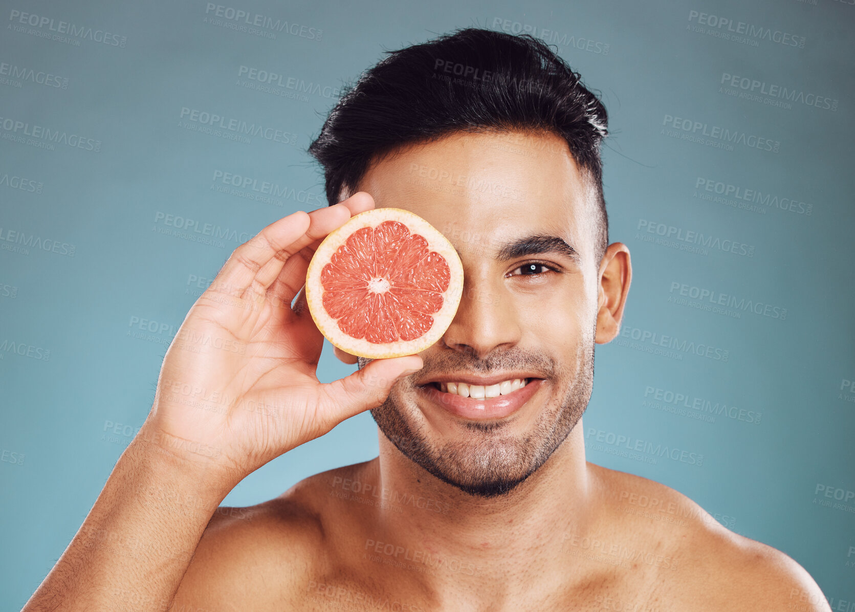 Buy stock photo Grapefruit, man and skincare in studio for vitamin c, healthy wellness and natural glow on blue background. Portrait of happy guy model face, nutrition and body detox for cleaning beauty cosmetics 