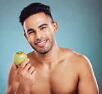 Diet, fruit and portrait of man ready for a healthy lifestyle for health and wellness. Food, raw and organic produce for vitamins and healthy living with nutrition on a blue studio background. 


