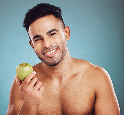 Buy stock photo Diet, apple and portrait of man for a healthy lifestyle for health and wellness. Fruit, raw and organic produce for vitamins and healthy living with nutrition on a blue studio background.  


