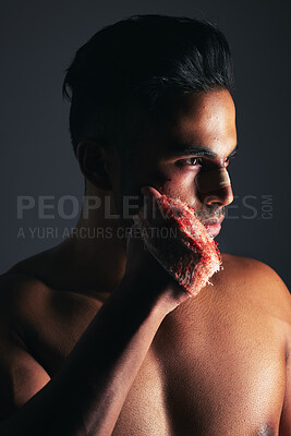 Buy stock photo Fight, boxing and man with fist injury after training against black studio background. Violence, fitness and boxer, fighter or athlete with focus and hand with blood after accident in sports action