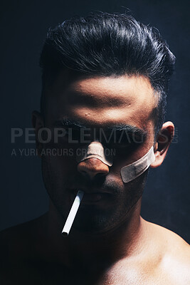 Buy stock photo Cigarette, boxer and man with fighting injury, wound and bandaid after fight, violence or accident in a dark studio. Portrait of fighter, shadow or gangster smoking after MMA match or crime 