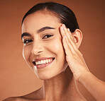 Portrait, skincare and hand of woman on face on brown studio background. Makeup cosmetics, aesthetic and female model from Canada touching skin after spa facial massage for healthy and clean skin.
