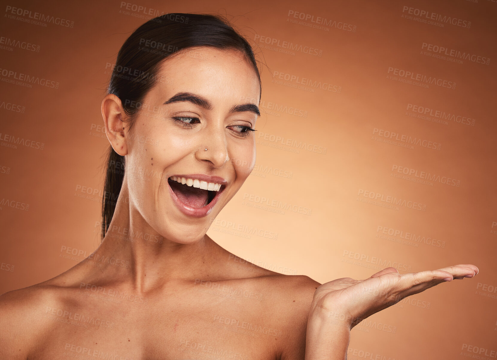 Buy stock photo Skincare, wow and hand of woman for marketing, advertising and happy against a brown mockup studio background. Spa, cosmetics and model with surprise in wellness and makeup and mock up space