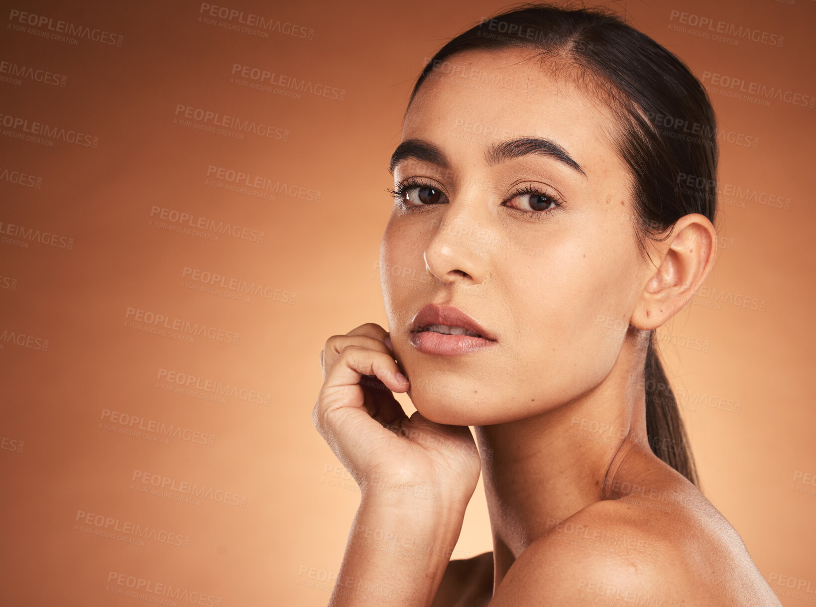 Buy stock photo Beauty, makeup and face portrait of woman on brown studio background. Wellness, aesthetic and skincare routine of young female model from Australia with luxury cosmetics, smooth skin or glowing skin
