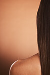 Beauty, hair care and skincare back view of woman isolated on brown studio background. Wellness, health and rear view of female model with long, healthy and beautiful, gorgeous and lovely silky hair.