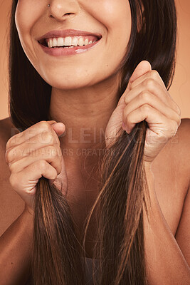 Buy stock photo Hands, hair and beauty with a model woman holding her hairstyle in studio on a beige background for keratin treatment. Salon, luxury and cosmetics with a female posing to promote a haircare product