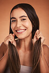 Portrait, happy and beauty woman with healthy hair and skin smiling against orange studio background. Latino model with skincare wellness and natural beauty with smile with strong healthy haircare
