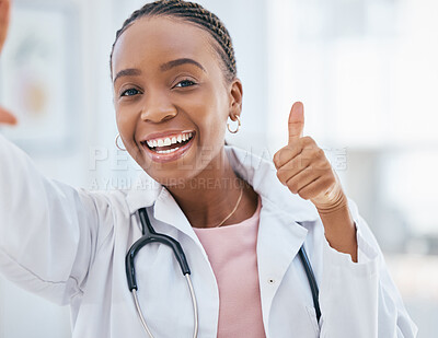 Buy stock photo Thumbs up, healthcare and medical with a black woman doctor working in the hospital for medicine or care. Thank you, hand sign and motivation with a female clinic professional saying yes with a smile