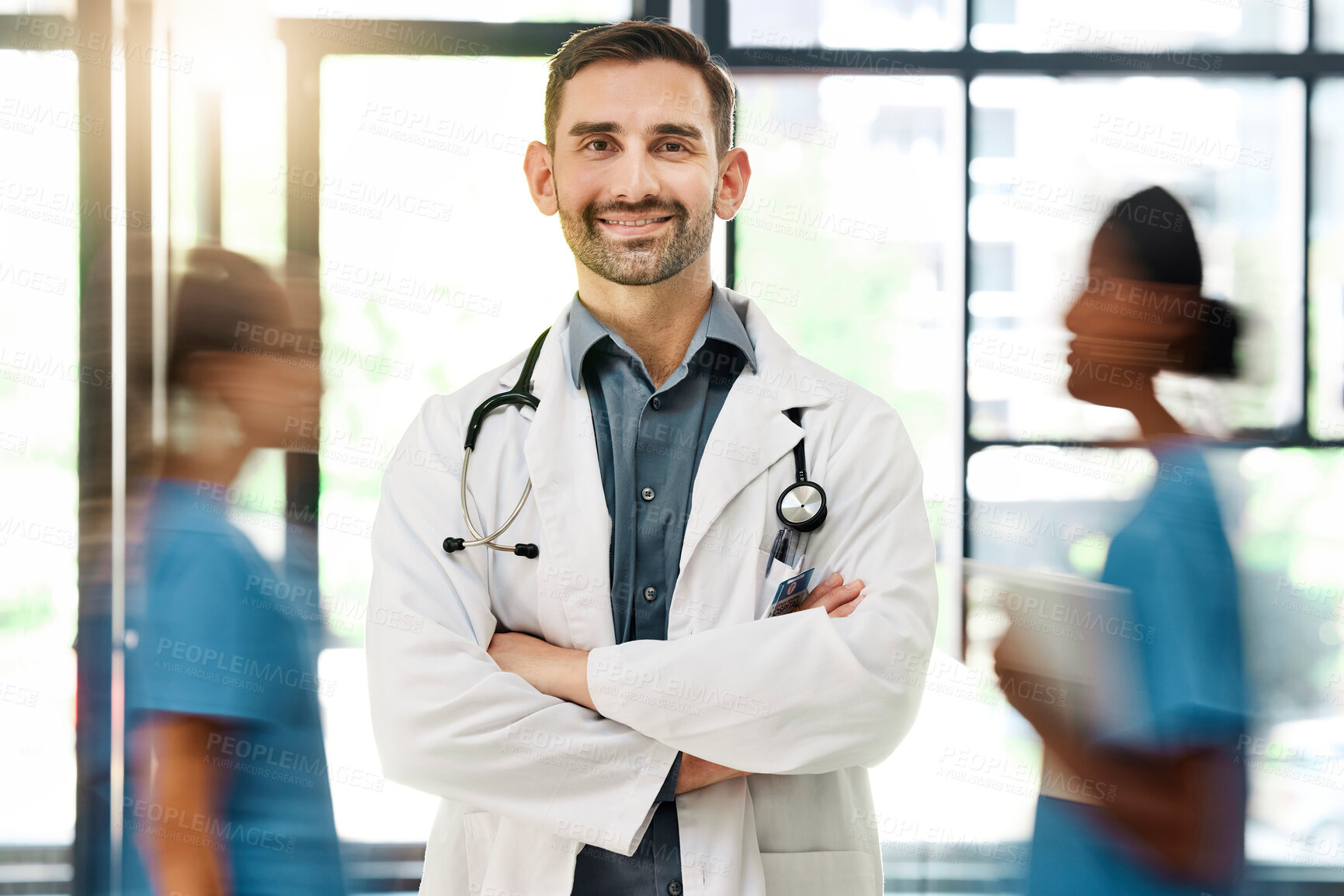 Buy stock photo Doctor, hospital and medical insurance with stethoscope and healthcare worker happy about career choice, service or  care. Portrait of male medicine or cardiology expert with busy staff for emergency