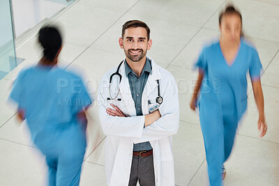 Buy stock photo Leadership, wellness or happy doctor in hospital with smile for motivation, insurance or healthcare with blurred busy background. Medicine, smile or nurse for health, medical help or vision in clinic