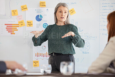 Buy stock photo Senior speaker, business woman and corporate meeting planning a marketing finance strategy. Business meeting, team and accounting leadership with a ceo working and speaking with corporate data 