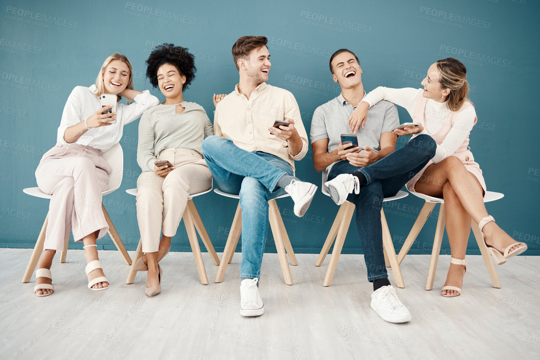 Buy stock photo Hiring, phone and recruitment with people in a room waiting, laughing and bond before interview, relax and happy. Candidate, unemployed and group sharing funny online meme, joke or social media 