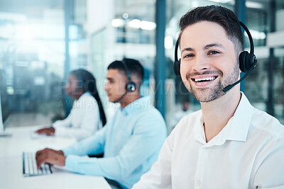 Buy stock photo Call center, telemarketing, and customer service consultant wearing a headset and looking happy at the office. Contact us and crm agent man with sales team for support, help and service with a smile
