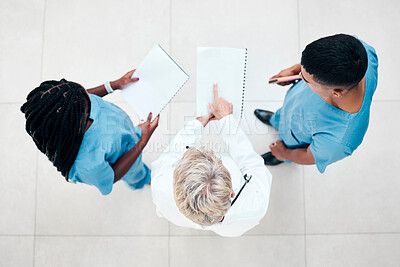 Buy stock photo Top view, doctor and nurses with patient results, diagnosis and treatment planning together in hospital. Health, medical professionals and discussion for healthcare, surgery strategy and consulting.