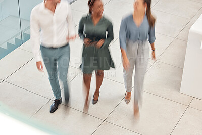 Buy stock photo Walking, blurred motion and office with a business man and woman team at work together from above. Working, collaboration and moving with a male and female employee group taking a walk at speed