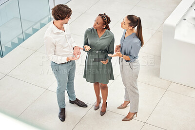 Buy stock photo Top view, tablet and business people in office lobby discussing project, idea or online planning. Teamwork, diversity or employees in corridor working together on tech, research or web surfing online