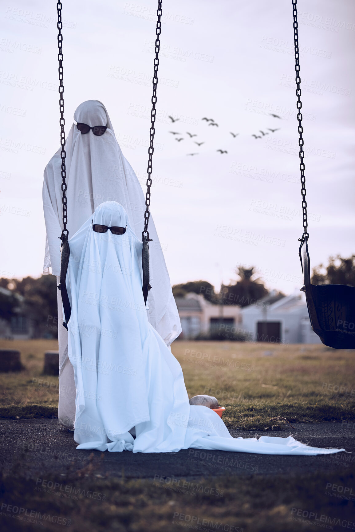 Buy stock photo Halloween, ghost costumes and sunglasses in the park for scary family holiday celebration together. Father or mother with child playing spooky dress up wearing sheets to terrorize the neighborhood