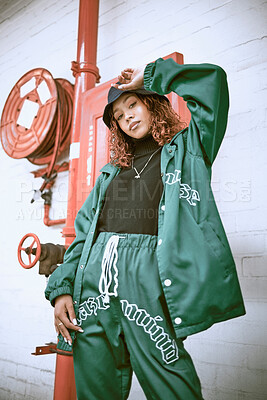 Buy stock photo Fashion, wall and black woman with green clothes, fashionable style or cool hip hop outfit. Fire hose, attitude or portrait of gen z girl with trendy streetwear, designer brand or 2000s rap aesthetic