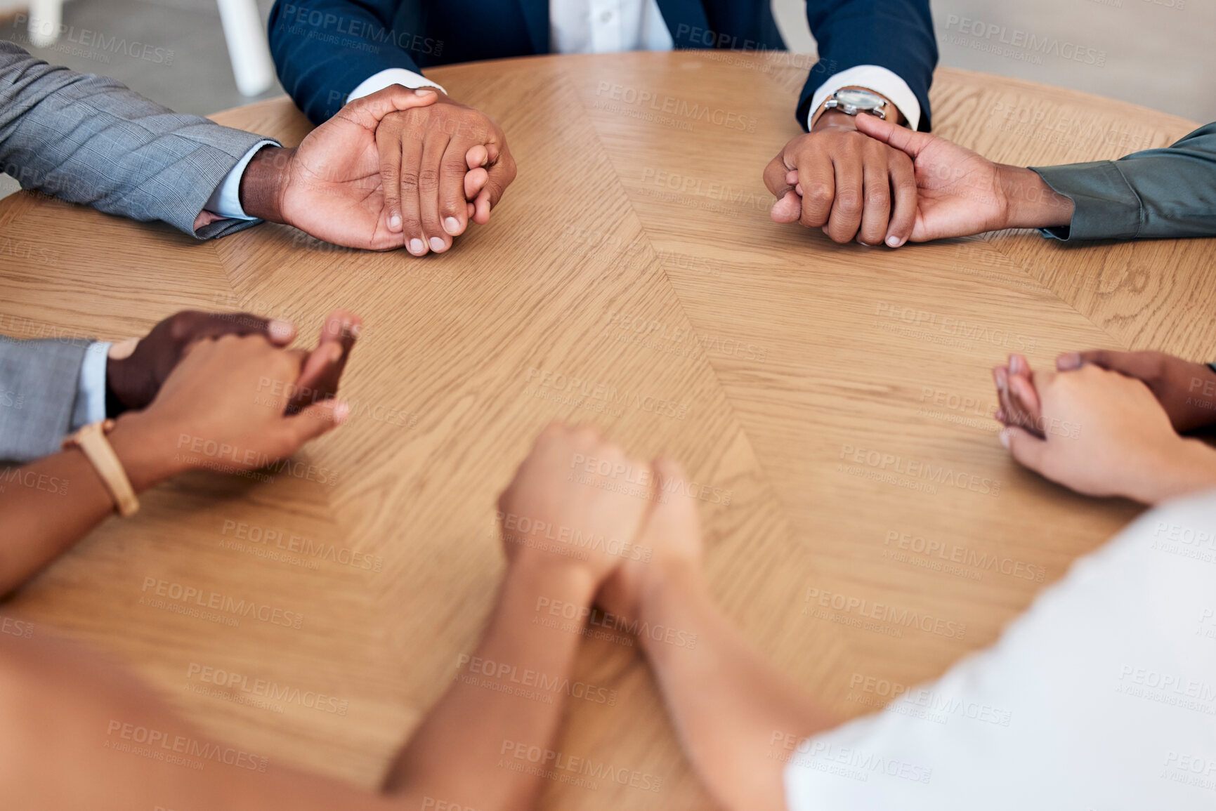 Buy stock photo Teamwork, trust and business people holding hands in meeting for support, unity and agreement. Collaboration, diversity and group of workers at desk with joined hands in circle, united together