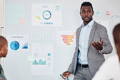 Buy stock photo Presentation, meeting and black man with feedback on marketing data to a team of employees at work. Planning, innovation and African manager talking about analytics, charts and results from business
