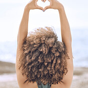 Yoga, zen and back view of black woman at beach on yoga mat