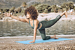 Yoga, fitness and black woman exercise at beach, stretching  in outdoor workout, flexible and mindfulness with zen. Body training, wellness and health in nature, strong and pilates in fresh air.