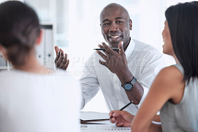 Buy stock photo Meeting, discussion and team working on a project together in a modern office conference room. Teamwork, collaboration and professional black man talking to his colleagues in the workplace boardroom.