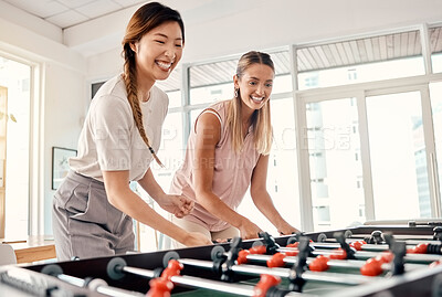Buy stock photo Foosball, women and friends playing table soccer in an office for fun, bonding and competition at work with happiness, energy and motivation. Employees enjoying football game for team building