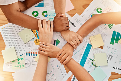 Buy stock photo Collaboration, support and team with joined hands with paperwork to plan a marketing project. Unity, diversity and business people working with documents for statistics, graphs and data in the office