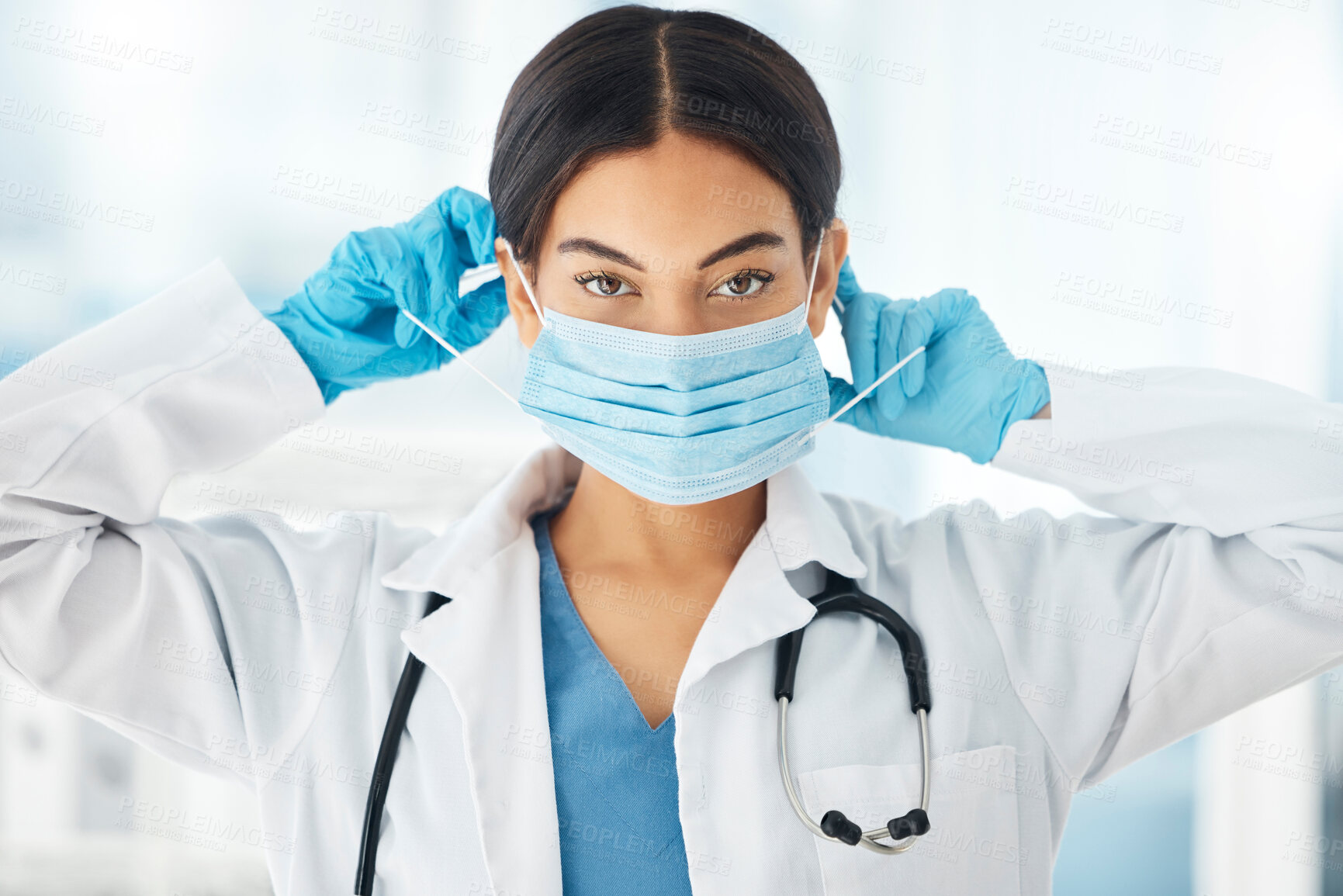 Buy stock photo Healthcare, covid and doctor hands on face mask for compliance in a hospital, safety and hygiene. Portrait, corona and woman health worker ppe for work during global pandemic, crisis and lockdown