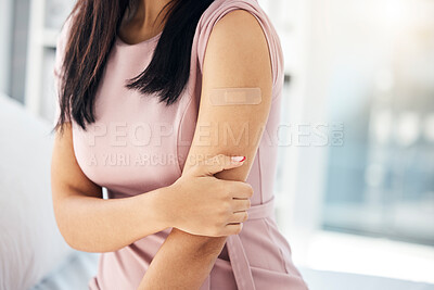 Buy stock photo Covid, vaccine and bandaid on arm of woman in hospital for medical, wellness and medicine. Healthcare, virus and flu injection with girl patient and plaster for first aid, sick or treatment in clinic