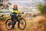 Cycling, sports and bike rider man on an outdoor, nature and mountain trail ready for a race. Portrait of a person with a bicycle outdoors for training, fitness and cyclist workout on a dirt trail