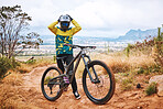 Mountain cyclist, bike and sports person on a outdoor nature road for a ride or sport race. Bicycle, fitness and workout training of an outdoors adventure athlete on a the mountains and dirt path