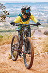Bike, biker and outdoor sport with athlete and mountain bike, adventure and extreme sports. Fitness, exercise and cyclist ride through dirt track, workout in woods and training with safety helmet.