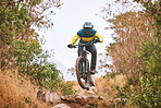 Bike, cyclist and sport, cycling in the woods, fitness and energy with extreme sports outdoor. Bicycle, exercise in nature and helmet for safety, active lifestyle and mountain biking in forest.