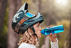Fitness, cycling and drinking water with man in mountain, training for sports, health and workout. Energy, nature and exercise with athlete and helmet for wellness, summer and bike riding in forest
