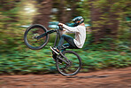 Bike, cycling and nature motor cross drive of a adventure, fast energy and sport man on a dirt road. Bicycle ride of a sports person on a forest trail in the woods with a cyclist and  race rider 