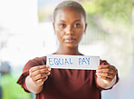 Equal pay, paper sign and black woman protest for women work salary rights outdoor. Portrait of a young person from Africa with a silent and serious protesting for female empowerment and equality