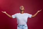 Happy black woman, open arms and advertising mockup for marketing against a red studio background. African American female model embracing freedom, sale or deal for product, announcement or welcome